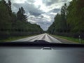 road with horizon on blue sky and white clouds view from the car. Royalty Free Stock Photo