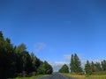 road with horizon on blue sky and white clouds view from the car. Royalty Free Stock Photo