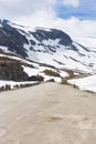 Road, house and mountain with snow in summer