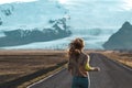 Road on Iceland, glacier, blond woman running Royalty Free Stock Photo