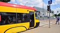 Road intersection and city traffic with cars and trams in Zoliborz district during the day.