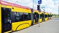 Road intersection and city traffic with cars and trams in Zoliborz district during the day.