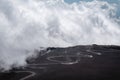 The road and jeep trucks above clouds on Mountain Etna volcano in Sicily, Italy. The biggest active volcano in Europe