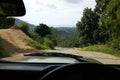 Road through jungle, view behind windshield of car Royalty Free Stock Photo