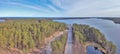 Road between lake and green pine forest aerial view Royalty Free Stock Photo