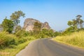 Road in Laos and the limestone formation at the background.