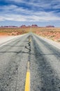 Road leading through beautiful desert landscape towards Monument Valley Royalty Free Stock Photo