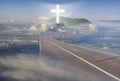 Road leading among the clouds to a glowing cross