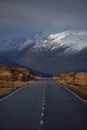 A road leading through the Scottish Highlands of Glen Coe to the snowcapped mountains Royalty Free Stock Photo