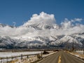 Road leading to Genoa Nevada with snowcapped mountains and dramatic clouds. Royalty Free Stock Photo