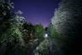 Road leading to the light under the starry sky Royalty Free Stock Photo