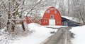 road leading to red barn and trees covered in fresh Winter white snow Royalty Free Stock Photo