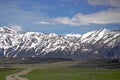 Road leading to snow-capped Teton mountains Royalty Free Stock Photo