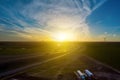 Road Leading to view of the Texas wind turbine farms in the colorful sunset showing Royalty Free Stock Photo