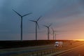 Road Leading to view of the Texas wind turbine farms in the colorful sunset showing Royalty Free Stock Photo
