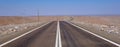 Road leading trough Atacama Desert landscape with sand, dunes and mountains, Andes near Huara, Chile Royalty Free Stock Photo