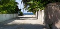 A road leads to Jetty in maldives where peoples takes ferry or boats. Road in Maldives local island