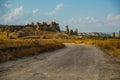 The road leads to the mountains and rocks shaped like mushrooms. Fairy chimneys. Cappadocia, Turkey Royalty Free Stock Photo
