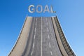 Road leads upwards in the blue sky, text GOAL, business concept