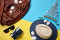 Road leather bag, straw hat, vintage photo camera, seashells and sailing yacht