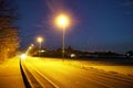 Road lights in night, street post shadow Royalty Free Stock Photo