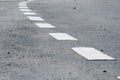 Road line marking made from white thermoplastic material.