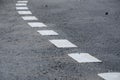 Road line marking made from white thermoplastic material.