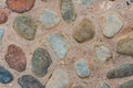 Road is lined with natural stones of various sizes and colors. Vintage stone background. View from above Royalty Free Stock Photo