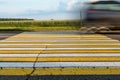 Road marking pedestrian crossing on cracked asphalt, moving car through pedestrian crossing or zebra lines Royalty Free Stock Photo