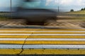 Road marking pedestrian crossing on cracked asphalt, moving car through pedestrian crossing or zebra lines Royalty Free Stock Photo