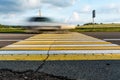 Road marking pedestrian crossing on cracked asphalt, moving car through pedestrian crossing or zebra lines Royalty Free Stock Photo