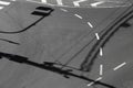 Road markings with shadows of traffic light, signs and poles Royalty Free Stock Photo