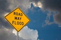 Road May Flood Sign Against A Blue Sky and Storm clouds. Royalty Free Stock Photo