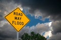 Road May Flood Sign Against A Blue Sky and Storm clouds.