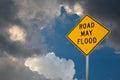 Road May Flood Sign Against A Blue Sky and Storm clouds.