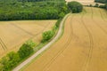 A road in the middle of forests and wheat fields in Europe, France, Burgundy, Nievre, in summer, on a sunny day Royalty Free Stock Photo