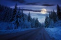 road through mountain landscape in winter at night Royalty Free Stock Photo