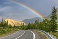 Road mountain rainbow forest cloudy Royalty Free Stock Photo