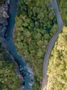 Road and mountain river through the green forest, Aerial view car truck drive going through forest, Aerial top view forest Royalty Free Stock Photo