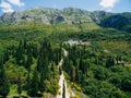 Road in the mountains through a grove of cypresses, rocky mountains in Montenegro. Royalty Free Stock Photo