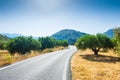 Road between the mountains and groves of olive trees Royalty Free Stock Photo
