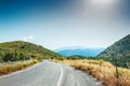 Road between the mountains and groves of olive trees. Royalty Free Stock Photo