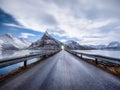 Road and mountains in the night, Lofoten islands, Norway. Asphalt and moonlight. Winter landscape with night sky. Long exposure sh Royalty Free Stock Photo