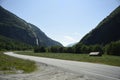 Road in the mountains, Norway. Summer landscape with road, mountain and small house.