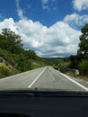 Road in the mountains seen from the windshield of the traveling car. In particular this is a view in Abruzzo, Italy