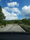 Road in the mountains seen from the windshield of the traveling car. In particular this is a view in Abruzzo, Italy