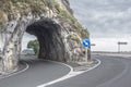 Empty road through the arch in the mountain