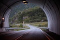 Road in the mountains with a tunnel. The road goes into the tunnel, the markings on the road Royalty Free Stock Photo