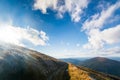 Road in the mountains, under a sunny sky. Cloudy. Mountain range clouds panoramic landscape. Autumn day in the mountains of Royalty Free Stock Photo