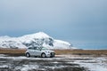 Wonderful nature in winter Iceland. Road in the mountains with the white travel car